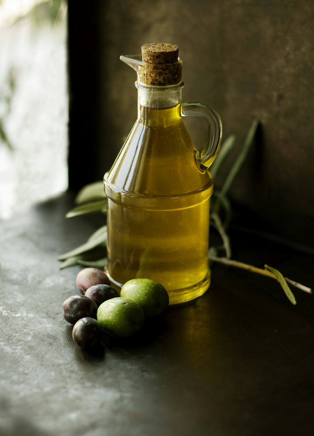 Extra virgin olive oil pouring from bottle